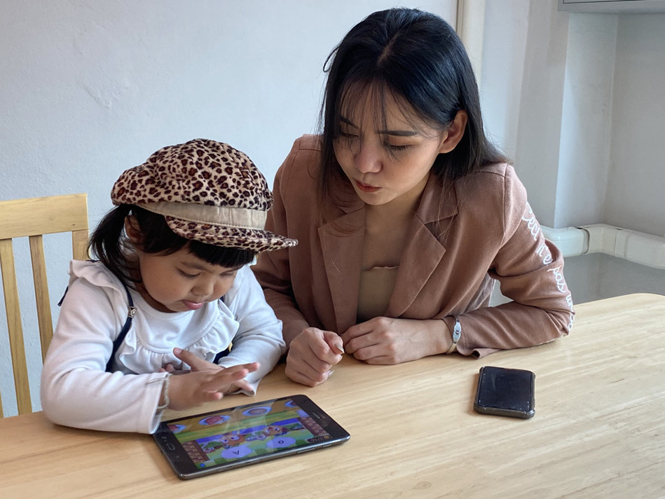 woman teaching girl English app