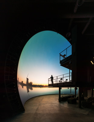 A Cosm team member admires the view of the newly constructed DomeX LED display. The free-standing truncated dome is 20-meter in diameter with an 8K resolution.