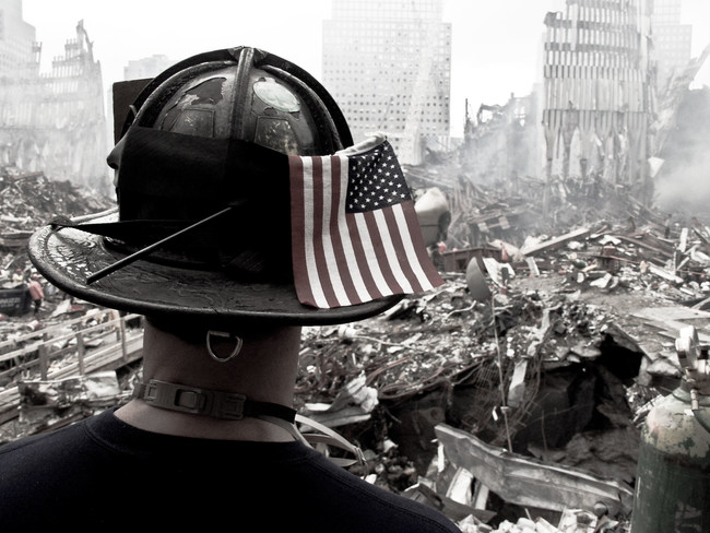 NY,NYC -September, 2001 FDNY firefighter keeping an eye on his team as they search voids on ground zero.