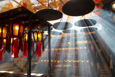 Inside Man Mo temple in Hong Kong with beautiful rim light from joss sticks and sunshine.
