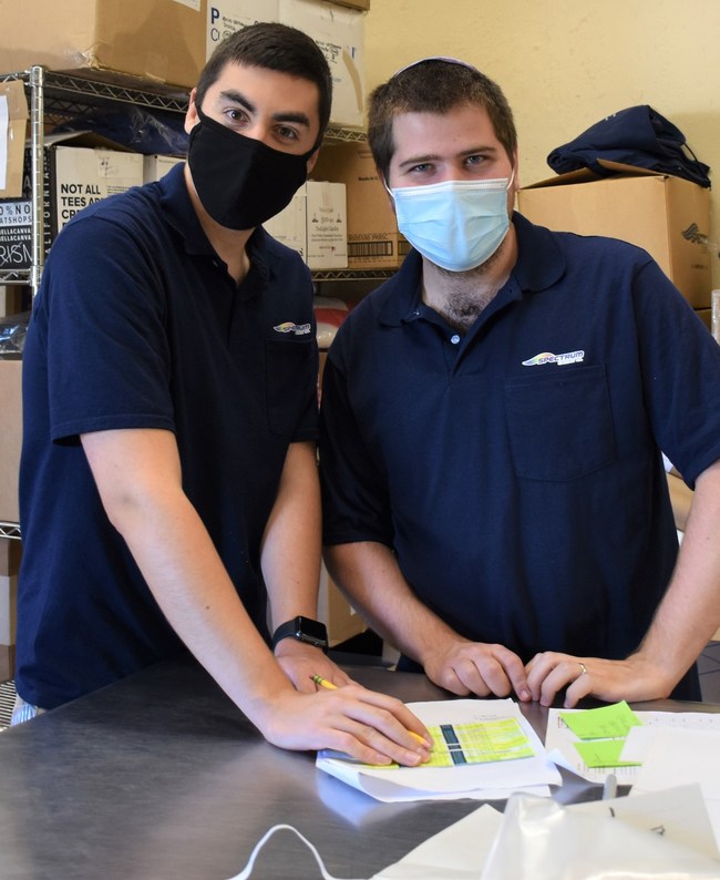 Spectrum Designs employees TJ and Josh filling an order for one of our cherished clients!