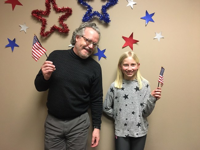 9-year-old Brenna Czycalla is pictured with her personal brain trainer at LearningRx Savage, Brad Olson. "She is very creative and artistic," said Olson. When she brought in her design to show Olson before her next training session, he told her "this is a winning idea. It was unique and unlike the other ideas I had seen."