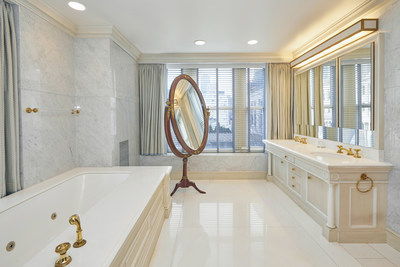 The master bath relies on bright marbles and stone with gilded fixtures and accents to create an elegant atmosphere in which one may prepare for, or wind down from, the day’s affairs. NewYorkLuxuryAuction.com.