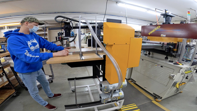 A JN White employee loads a Preco Automated Die-Cutting machine at the company's Perry, NY manufacturing facility. 