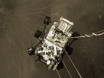 This high-resolution still image is part of a video taken by several cameras as NASA’s Perseverance rover touched down on Mars on Feb. 18, 2021. A camera aboard the descent stage captured this shot. A key objective for Perseverance’s mission on Mars is astrobiology, including the search for signs of ancient microbial life. The rover will characterize the planet’s geology and past climate, pave the way for human exploration of the Red Planet, and be the first mission to collect and cache Martian rock and regolith (broken rock and dust). Subsequent NASA missions, in cooperation with ESA (the European Space Agency), would send spacecraft to Mars to collect these cached samples from the surface and return them to Earth for in-depth analysis. The Mars 2020 mission is part of a larger program that includes missions to the Moon as a way to prepare for human exploration of the Red Planet. JPL, which is managed for NASA by Caltech in Pasadena, California, built and manages operations of the Perseverance and Curiosity rovers. (Credit: NASA/JPL-Caltech)