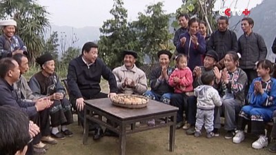 photo of President Xi Jinping with people in poor region (PRNewsfoto/CCTV+)