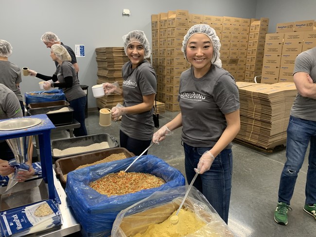 Prior to COVID-19, ShopCore employees Rishika Mahtani and Grace Han volunteer at hunger event in Chicago for CoreGiving.