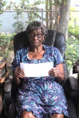 Annie Green, a resident of Town Center Apartments in Opa Locka, Fla., is happy to receive help from ChenMed and the city's Community Development Corporation to pay her utility bill.
