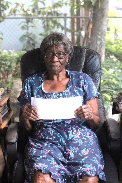 Annie Green, a resident of Town Center Apartments in Opa Locka, Fla., is happy to receive help from ChenMed and the city’s Community Development Corporation to pay her utility bill.