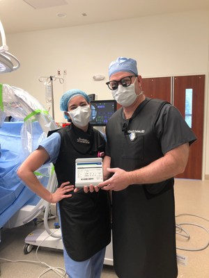 Dr. Jeffrey Carlson of OSC and Ashley Bennett of Boston Scientific in operating room before implanting the spinal cord stimulator.