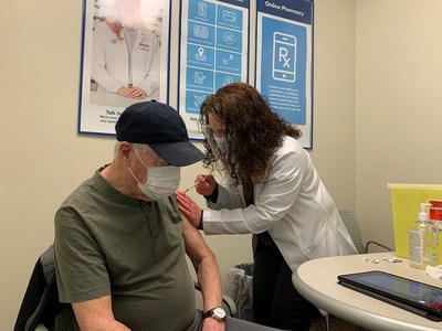 Shoppers Drug Mart Associate Owner Colleen O'Connor gives the store’s first COVID-19 vaccine to Kevin Corbett in Port Hawkesbury, NS. (CNW Group/Loblaw Companies Limited)