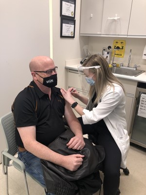 Shoppers Drug Mart Pharmacist Michelle Ernest gives the store’s first COVID-19 vaccine to Rob Margetts in Brandon, Manitoba. (CNW Group/Loblaw Companies Limited)