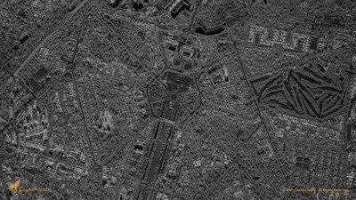 This nighttime SAR image shows the Rajpath, the large ceremonial boulevard in New Dehli, leading to the India Gate. The reflected energy shows the arch of the monument as well as a large gathering of vehicles in front of the monument. This is an important site for analysts as the hexagonal park is the site of national parades and protests. Other features include the National War Museum, National Stadium and the sand traps of the Dehli Golf Club.