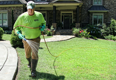 An Eastern Turf Maintenance team member treats a customer lawn.