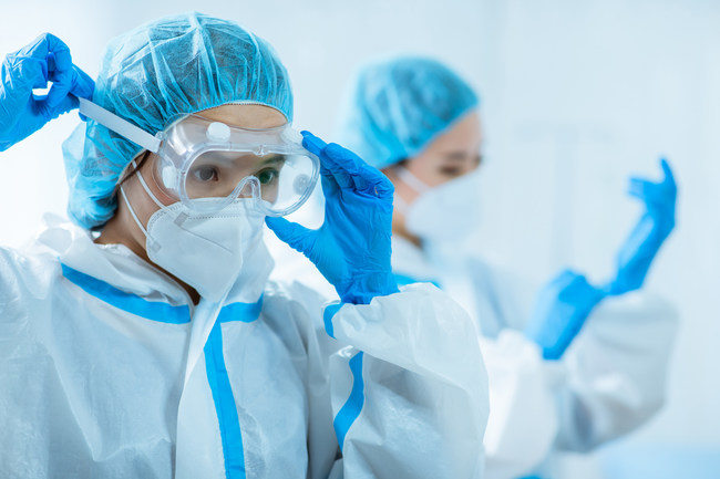 Medical personnel dress in PPE before interacting with patients during the COVID-19 outbreak.