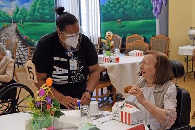Residents at Nazareth Home in Louisville, Ky., enjoy meals donated from their local KFC, as part of KFCs donation of one million pieces of chicken to seniors across the country who have been increasingly isolated during the past year.