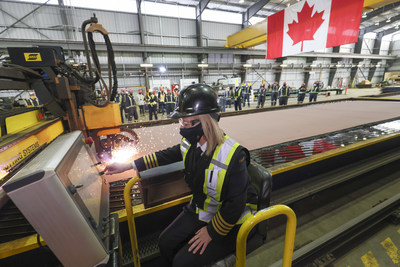 The Canadian Coast Guard's Heather McDonald cuts the first steel at Seaspan's Vancouver Shipyard, marking the start of construction of Canada's most modern science research ship. (CNW Group/Seaspan Shipyards)