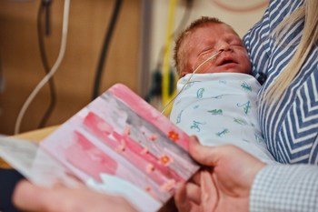 Newborn Enoch Lober of Tennessee is a NICU patient at Cincinnati Children's. His parents are part of the NICU Bookworms program and enjoy reading to him.