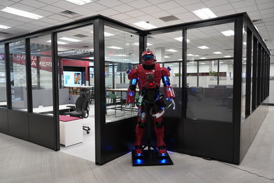 Morrell Group Motioneer in front of a new collaborative workspace for the newly developed department, customers, and vendors inside Morrell Group's Auburn Hills, MI Headquarters.