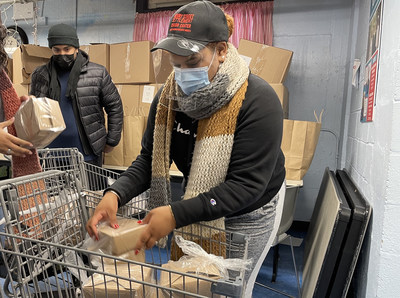 Volunteers at the food pantry at New York's Henry Street Settlement wear InstaShield as they pack free meals and deliver them to seniors who are unable to shop because of the pandemic.