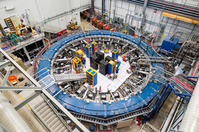 The Muon g-2 ring sits in its detector hall amidst electronics racks, the muon beamline, and other equipment. This impressive experiment operates at negative 450 degrees Fahrenheit and studies the precession (or wobble) of muons as they travel through the magnetic field.