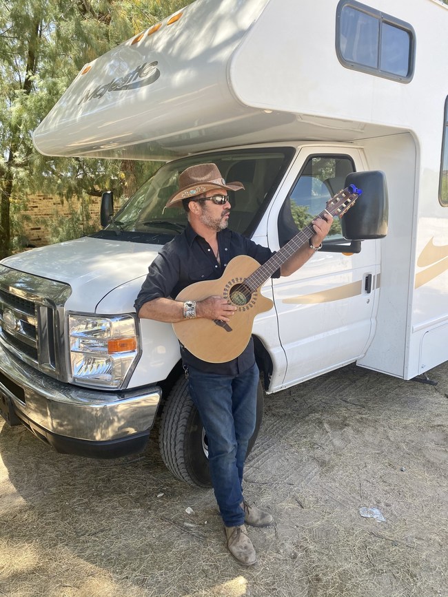 Dr. Tom - playing guitar at campsite in Arizona