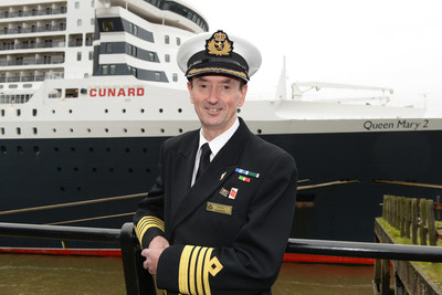 Cunard Captain Christopher Wells standing in front of flagship Queen Mary 2. As Wells embarked on his retirement this week, he was awarded the rank of Commodore in recognition of his 20 year career with the brand.
