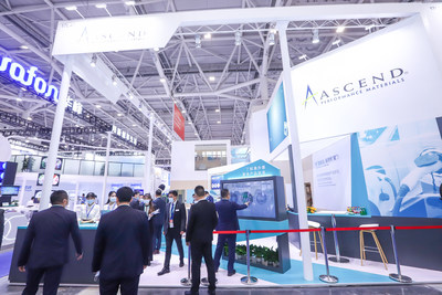 Visitors at Ascend Performance Materials' Chinaplas booth exploring the company's latest products via touchscreen.