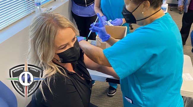 Christy Doyle, the Chief Human Resource Officer at Quality One Wireless, receives the first dose of the Moderna mRNA COVID vaccine at Q1's Orlando facility on Tuesday, April 13th.