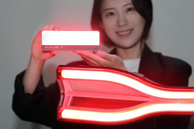 An LG Innotek employee is holding the automotive lighting module Nexlide-E. This product is 63% brighter than the previous product and produces uniform light. It can be applied to the front/rear of an automobile. (PRNewsfoto/LG Innotek)