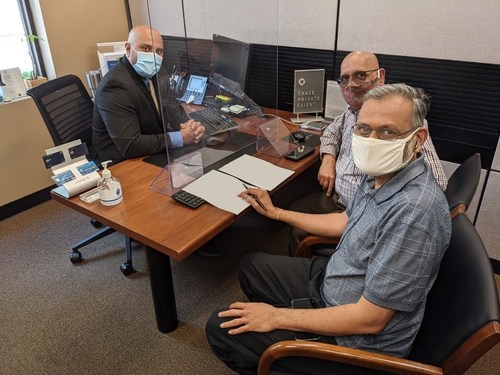 Photo: Arun Kankani, President, Sewa International, foreground, and Yagnesh Patel, Compliance Manager, to his right, wiring the money from a bank in Houston to purchase 2,184 Oxygen-concentrators.