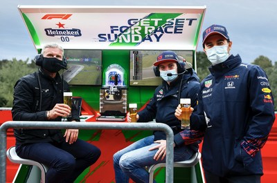 Heineken ambassador David Coulthard poses at the Heineken F1 Pit Wall Bar with Red Bull Racing Honda drivers Max Verstappen of the Netherlands and Sergio Perez of Mexico. (Photo by Mark Thompson/Getty Images for Heineken)