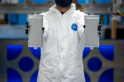 A Solid Power manufacturing engineer holds two 20 ampere hour (Ah) all solid-state battery cells for the BMW Group and Ford Motor Company. The 20 ampere hour (Ah) all solid-state battery cells were produced on Solid Power’s Colorado-based pilot production line.