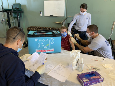 Thermal Custom Packaging Totes Maintaining COVID Vaccines Refrigerated 2-8 Centigrade During a Vaccination Clinic.