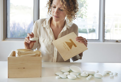 A woman opens a box of Parting Stone solidified remains.