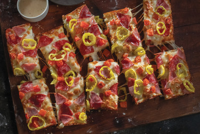 Jet's Italian Hero Pizza, topped with premium mozzarella, salami, ham tomatoes, and mild peppers with Italian dressing drizzled on top.