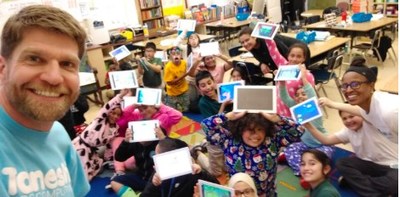 Tanoshi team handing out 2-in-1 computers to a classroom in Oakland, CA.