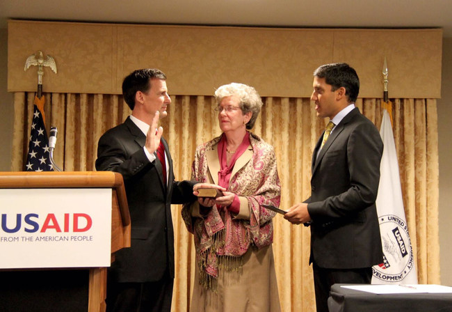 Dave Harden, left, being sworn into duty for USAID