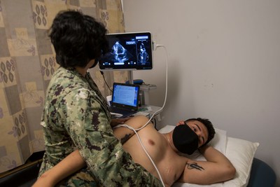 U.S. Navy Hospital Corpsman 3rd Class Victoria Diaz, with the Naval Medical Research Center, conducts an ultrasound of a Marine participant using Caption AI with the COVID-19 Health Action Response for Marines<br />
(CHARM) study on Camp Johnson. (U.S. Marine Corps photo by Sgt. Jesus Sepulveda Torres)