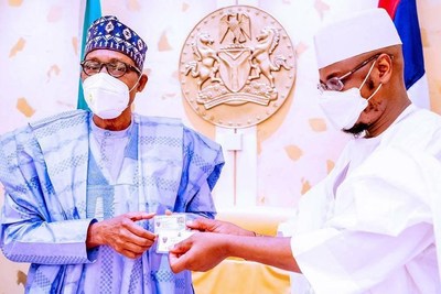 President of the Federal Republic of Nigeria Muhammadu Buhari is showing the NIMC (National Identity Management Commission) NIN (National Identity Number) slip – that can be verified against the central national ID database leveraging OSIA interface