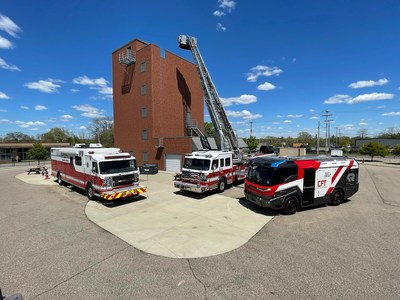 America's first electric fire truck on display (far right), alongside existing fire trucks, for firefighters across the midwest.