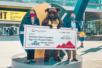 Mountain America's President and CEO, Sterling Nielsen, presents a $62,000 check to Dr. Beckerle, CEO at Huntsman Cancer Institute, during the May 8 Utah Jazz game.