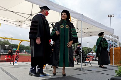 UIW President Dr. Thomas M. Evans congratulates Dr. Maria Ahmad, the very first graduate of the inaugural class of the UIW School of Osteopathic Medicine