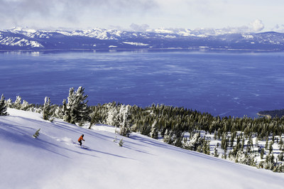 Skier in fresh powder overlooking Lake Tahoe in Heavenly, CA. Source: Danhoun