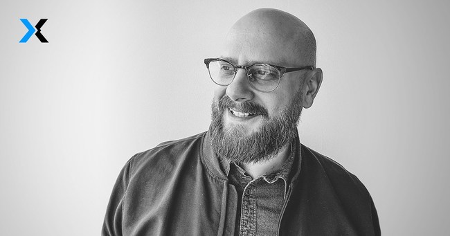 A black and white headshot of FlexDealer CEO, Michael Cirillo smiling into the distance