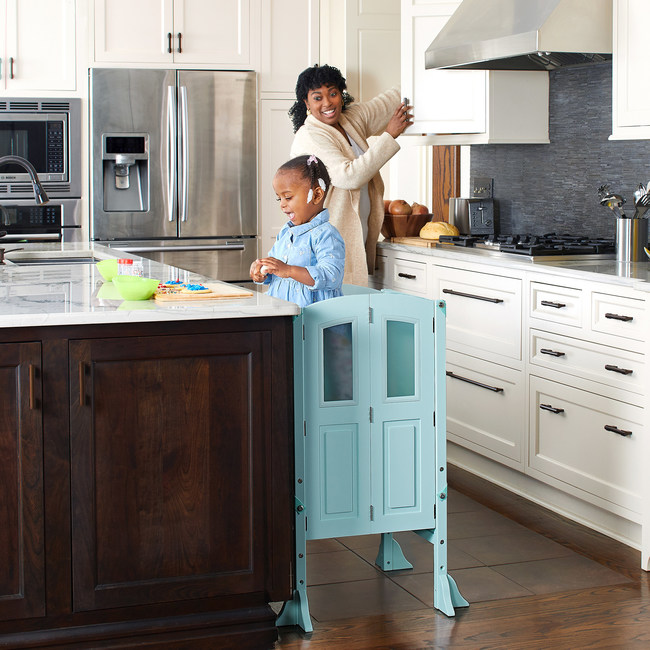 The Martha Stewart Kitchen Helper features a new design inspired by fine, custom kitchen cabinetry and comes in four trending color choices; creamy white, charcoal, taupe, and mint green. Details, such as the inset acrylic windows, two mesh Keepers, a non-slip mat, and a secure, adjustable platform for growing children, all support the mission of providing the safest way to elevate young children to countertop height promoting their feeling of independence as well as family togetherness.