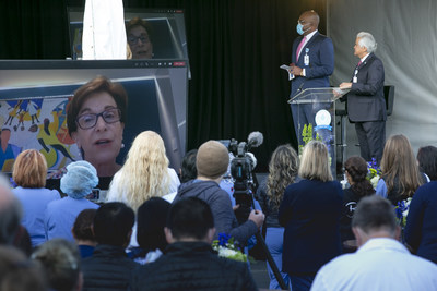 SVMHS President/CEO Pete Delgado and Chief Operating Officer Clement Miller surrounded by nurses and other staff listening to live video announcement from the Chair of the Commission for the Magnet Recognition Program®