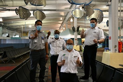 From left to right, Holland America Line Koningsdam crewmembers Romeo Palmes, senior plumber; Errol Nelson, hotel director; Dedy Laluyan, hotel controller; and Lazar Mihajloski, purser, hold their COVID vaccinations cards. Sharp HealthCare administered more than 100 shots to crewmembers Wednesday morning at the San Diego Cruise Terminal.