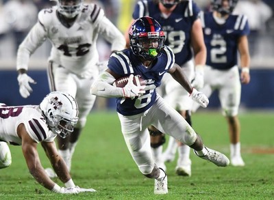 Ole Miss wide receiver Elijah Moore (8) makes a catch against Mississippi State Bulldog defenders during Nov. 28, 2020 SEC game in Oxford, Mississippi. Moore won the C Spire Conerly Trophy Monday as the best college football player in Mississippi. - photo courtesy of SEC Media Pool