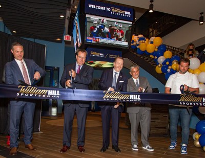 (Left to right) Eric Hession (Co-President - Caesars Sports & Online Gaming), Tom Reeg (CEO - Caesars Entertainment), Jim Van Stone (President, Business Operations & Chief Commercial Officer - Monumental Sports & Entertainment), Ted Leonsis (Founder & CEO - Monumental Sports & Entertainment) and Nicholas Stefanelli (Michelin-Starred Chef) perform a ceremonial ribbon cutting as William Hill and Monumental Sports & Entertainment celebrate the grand opening of the William Hill Sportsbook, America’s first in-arena sportsbook, at Capital One Arena on Wednesday, May 26, 2021 in Washington D.C. (Credit William Hill)